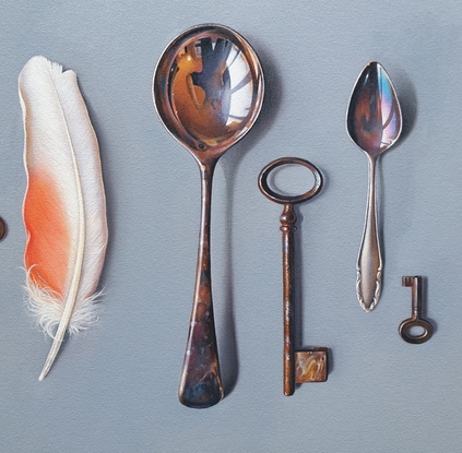 Old cutlery and vintage keys arranged in a raw with  sea glass , driftwood and Pink Cockatoo feather to emphasize the beauty of manmade and natural things.