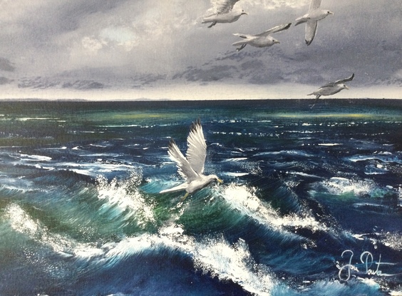 Seagulls gliding above the waves