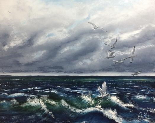 Seagulls gliding above the waves