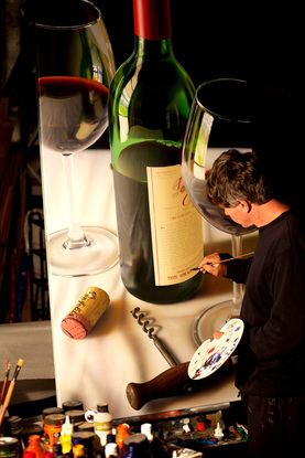 A 3' by 6' canvas of a huge bottle 1990 Penfolds Grange . Created in hyper realism style sharp and in focus enlarges a 500 times . There are two glasses  of red wine plus a cork and antique cork screw on a white table cloth. 