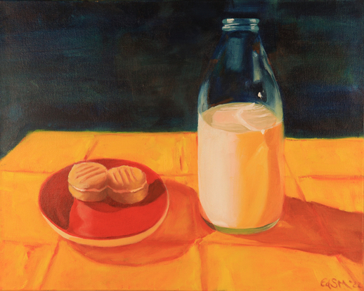 Two melting moments sit side by side in a red saucer. Next to this on the right there is a glass bottle of milk, 3/4 full. These are both sitting on a bright yellow tablecloth. The background is a dark bluel