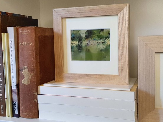 Small landscape oil painting of a silvery calm river with reflections of forest.