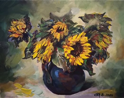 A vase of sunflowers are on a light green background. 