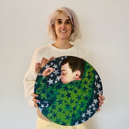 A portrait of a boy sleeping wearing green star pajamas.