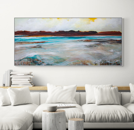 Abstract seascape in spring tones of yellow, blue  and teal with mountain range in the horizon under a dramatic cloudy sky.