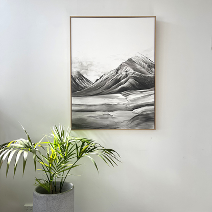 A landscape painting in black and white watercolour. a mountain top and valley with a hint of clouds at their peak. The lower foreground has watery rock forms that seem to blur as it gets closer. 