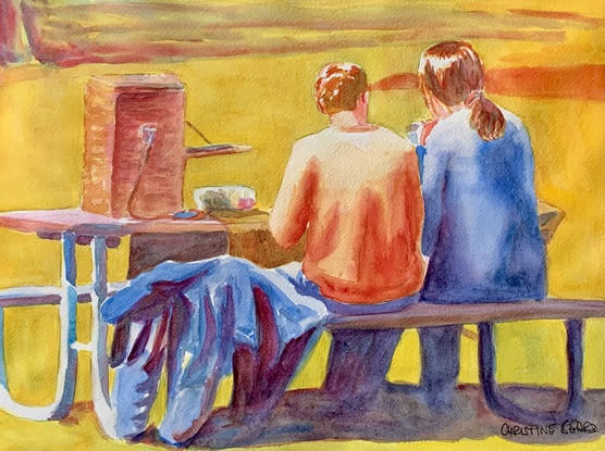 Couple have a picnic in the sunshine.