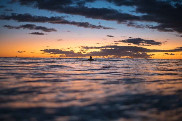 Surfer silhouette at sunrise