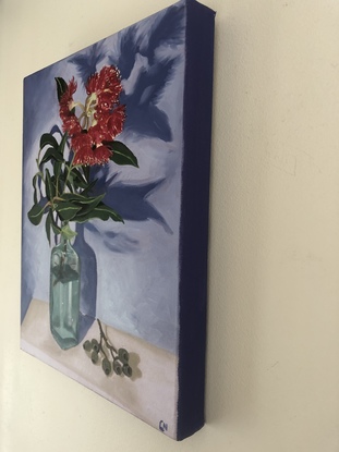 Red gum blossom in vase with gumnuts 