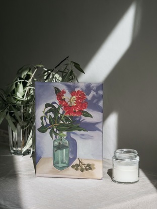 Red gum blossom in vase with gumnuts 