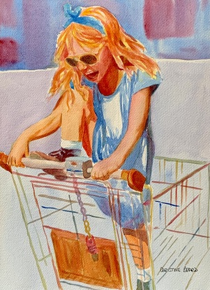 Young girl plays in a shopping cart in the sunshine.