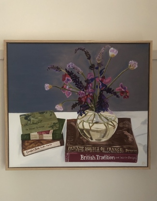 Flowers in circular vase on book stack