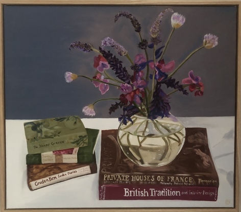 Flowers in circular vase on book stack