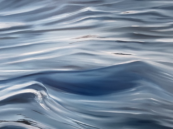 Ripples and reflections on a deep ocean surface with the perspective of being on a boat or pier