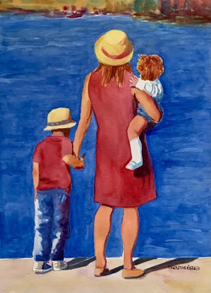 Young boy and his family gaze at the ocean in the sunshine.