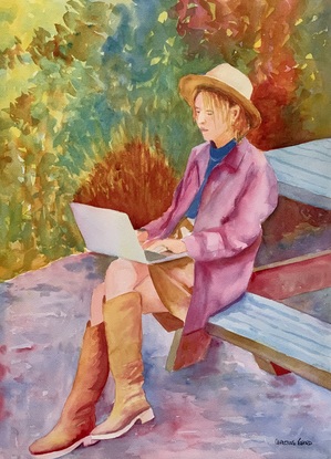 Woman working on her laptop in the park.