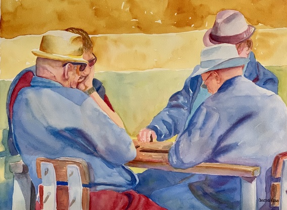 Men playing dominoes in the park.