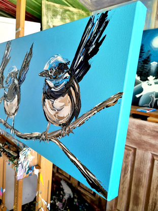 four fairt wrens painted in texture on a bright blue background