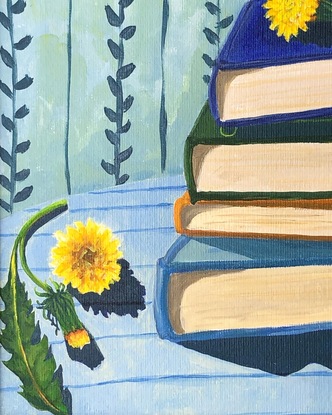 Pile of books on a striped blue tablecloth, with dandelions and vine wallpaper behind. 