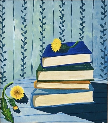 Pile of books on a striped blue tablecloth, with dandelions and vine wallpaper behind. 