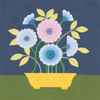 Bunch of blue and purple daisy flowers extending from bright yellow pot sitting on olive green table with navy wall behind.