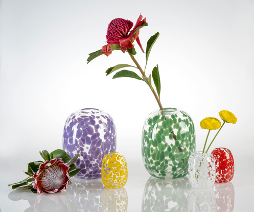 Large, rounded clear glass vase with opaque white spots