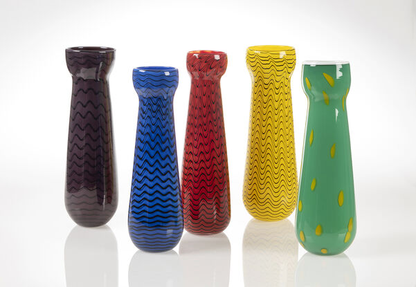 Set of five vases, five different colours, tall with black wiggly lines wrapping around in a spiral.