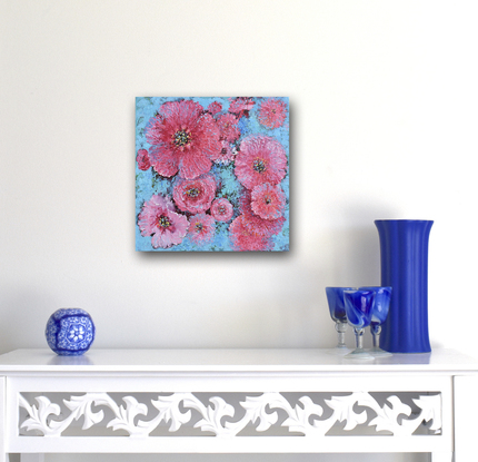 A thickly textured oil painting of pink poppies on a decorative blue background, 