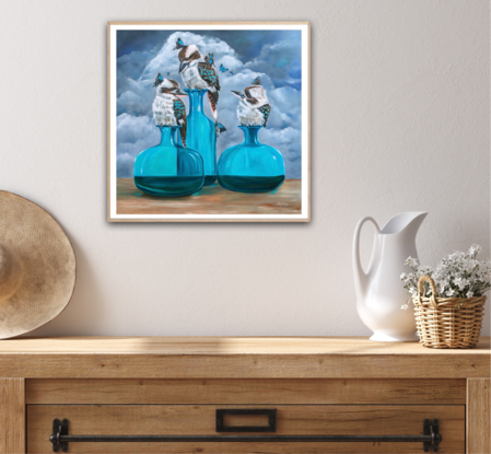 Three kookaburras sitting on glass vases against a stormy background. 