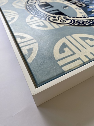 A Chinese restaurant interior depicted on a blue and white china plate set on a blue and white patterned wallpaper.