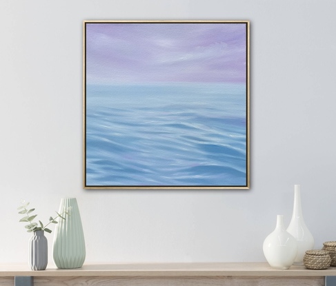 Blue ripples on ocean surface under purple sky