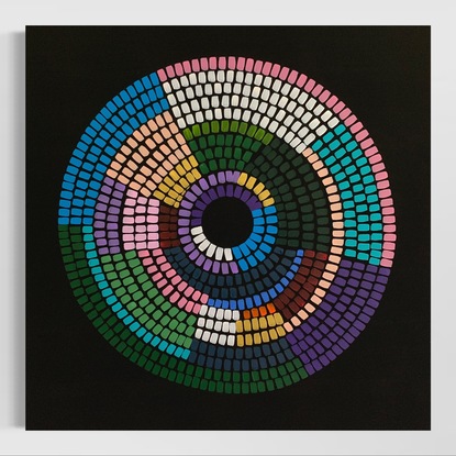 Circular shape made up of vibrant colours on black background 