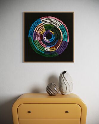 Circular shape made up of vibrant colours on black background 