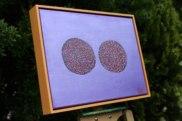 Freckle chocolates on a purple background.