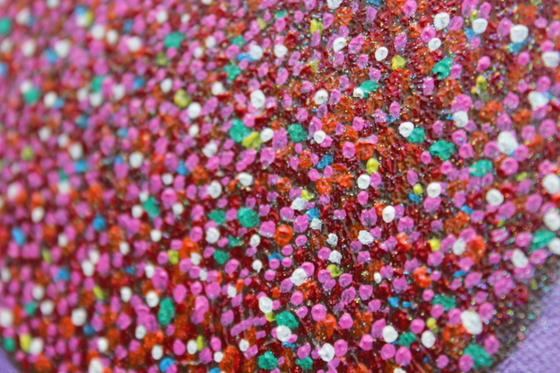 Freckle chocolates on a purple background.