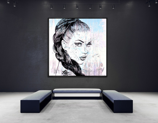 A large canvas painting using acrylics.  An abstract splash of colours on white/cream is the backdrop for the simple sketch (in black)  the face of a beautiful woman with intense eyes that follow you around the room.  She has a long braid of dark hair that feames her face.  The artist has skillfully sketched every hair.  
On the bare shoulder to the woman is a tattoo - the symbol for luck!

It is the type of painting that can fit any room and will have impact while the subtle colours accenting the design and decor of the room.