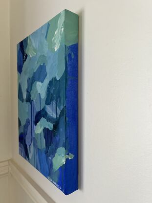 Varying shades of deep blues and pale greens expressively pieced together with drips and spatters