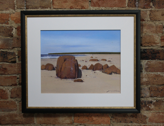 Rocks and sand and a view south along Dolphin Beach, Moruya.