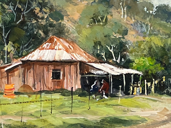 A very old cottage on a country road with hillside as its backdrop