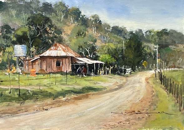 A very old cottage on a country road with hillside as its backdrop