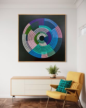 Circular shape made up of bright vibrant strokes, blues pinks purples on a black background. 