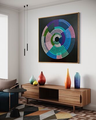 Circular shape made up of bright vibrant strokes, blues pinks purples on a black background. 