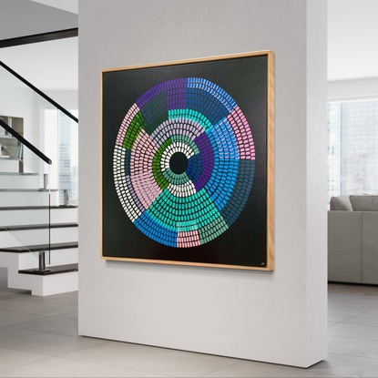 Circular shape made up of bright vibrant strokes, blues pinks purples on a black background. 