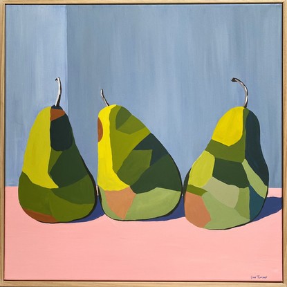 3 green pears in triangle formation on a pink surface before a grey wall.