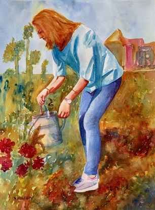 Woman waters her plants.