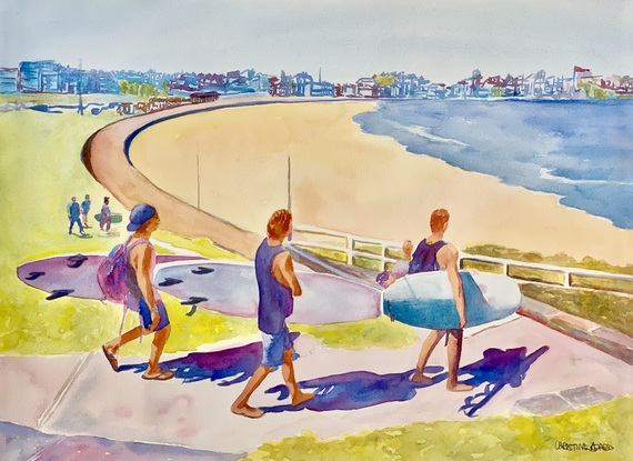 Surfers make their way to the beach.