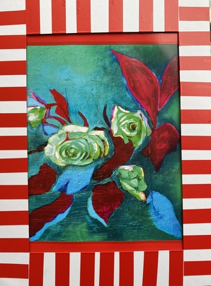 Brightly coloured green and blue roses with red leaves