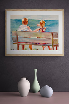 Children sit on a bench overlooking the sea.