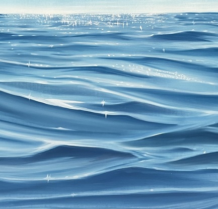 Moving ocean surface a under blue sky