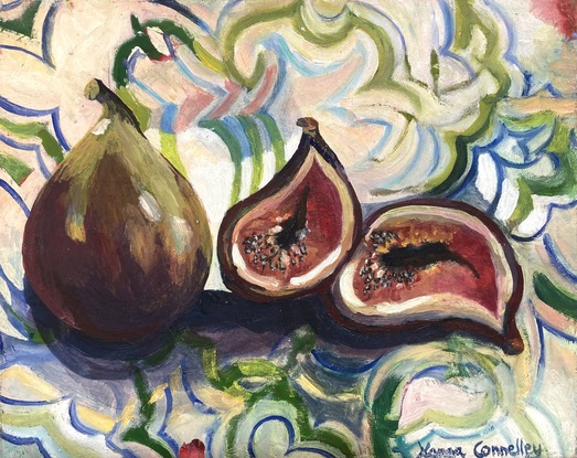 Two ripe delicious figs on a European patterned cloth.